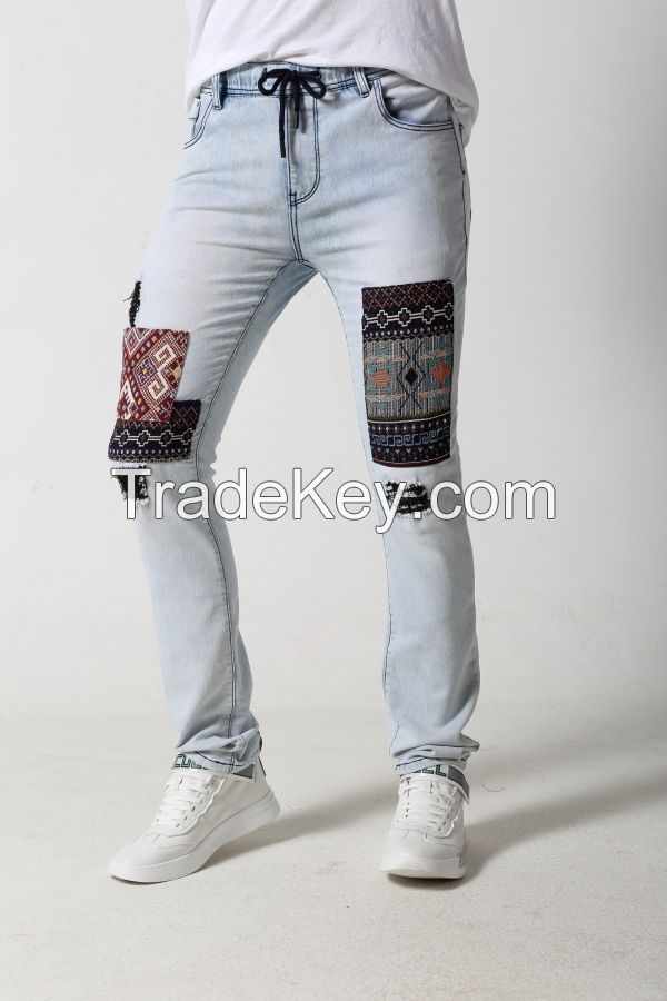 Men's slim distressed denim jeans with jacquard patches