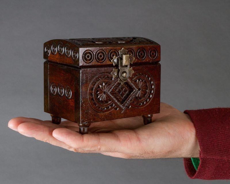 Small wooden brown jewelry box.