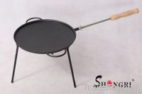 pre-seasoned grill on three legs with wood handle
