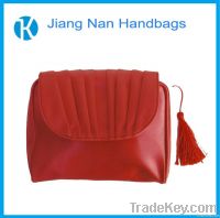 red luxurious makeup bag with tassel